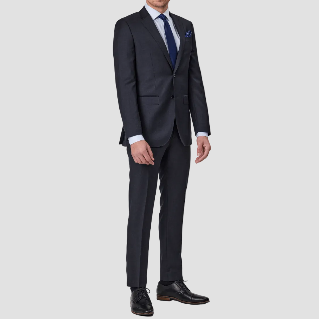 Charcoal wool blend single breasted, two buttoned suit by Savile Row with a blue tie and pocket square.