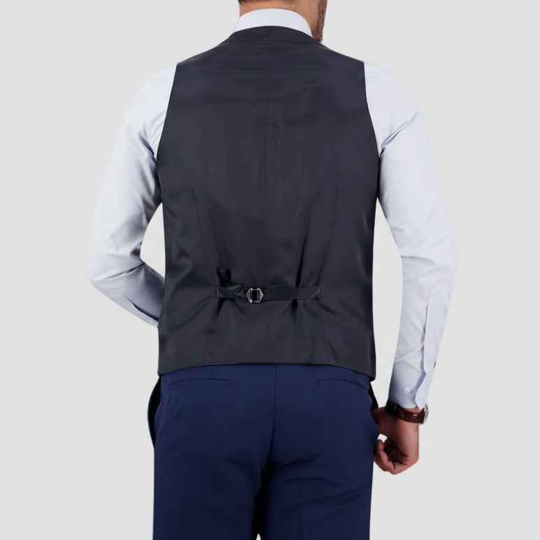 Back view of a men’s denim-blue waistcoat, featuring an adjustable satin back strap, worn over a light blue shirt and paired with matching denim-blue trousers.