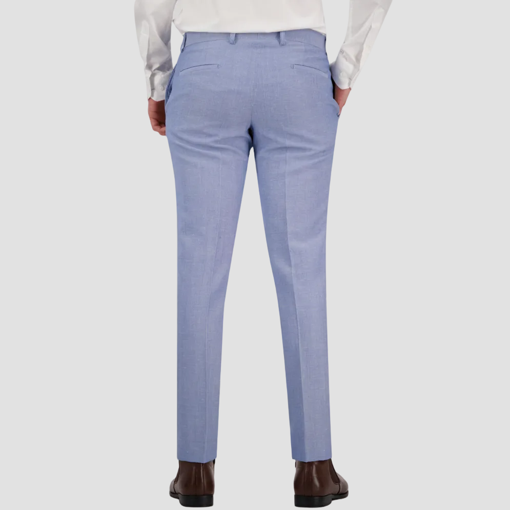 A man wearing a sky blue tailored fit suit trouser by Savile Row, paired with a white shirt and brown shoes.