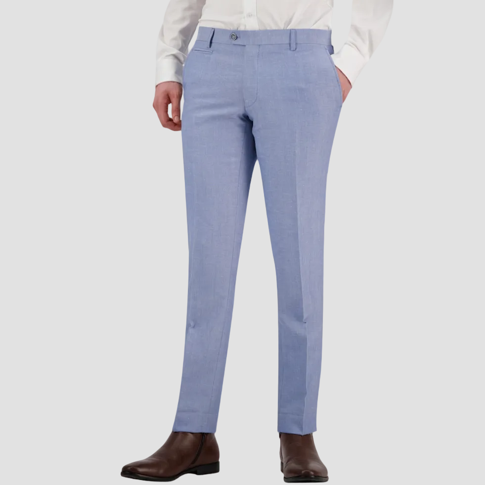 A man wearing a sky blue tailored fit suit trouser by Savile Row, paired with a white shirt and brown shoes.