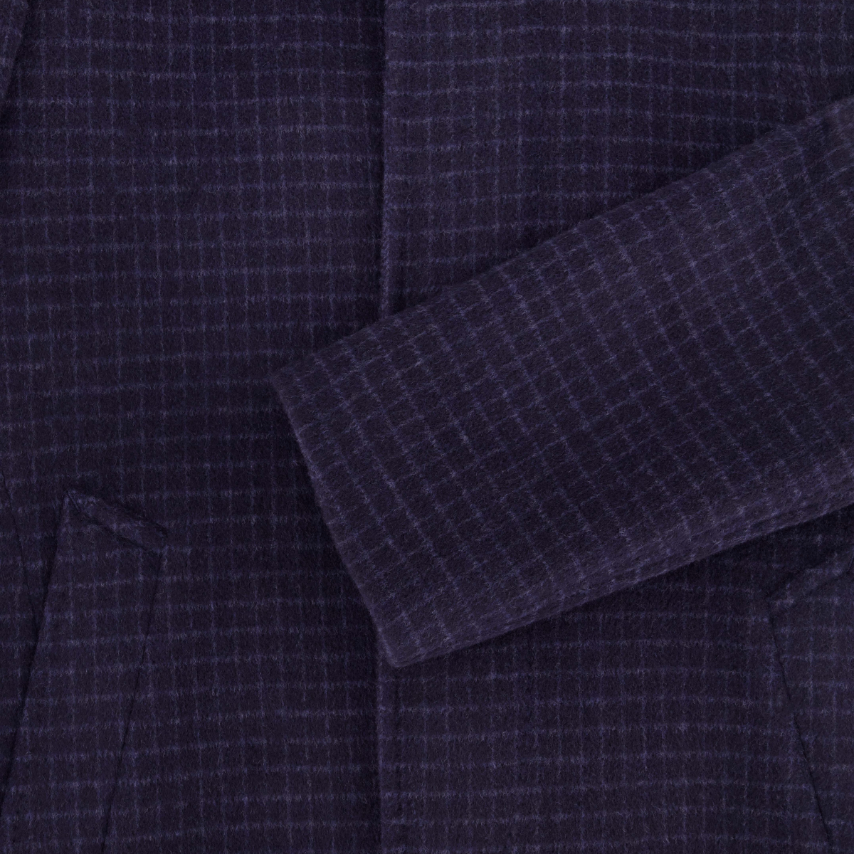 Close up of a navy check wool cashmere blend men's overcoat.