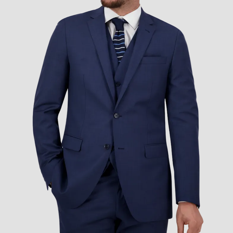 A man wearing a blue two-piece Savile Row suit with a notch lapel, vest, white shirt and tie.