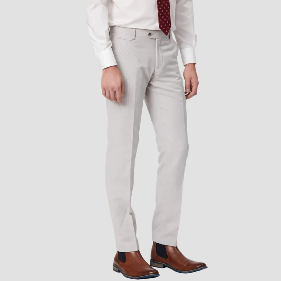 Person wearing salt pants, white shirt, and brown shoes 