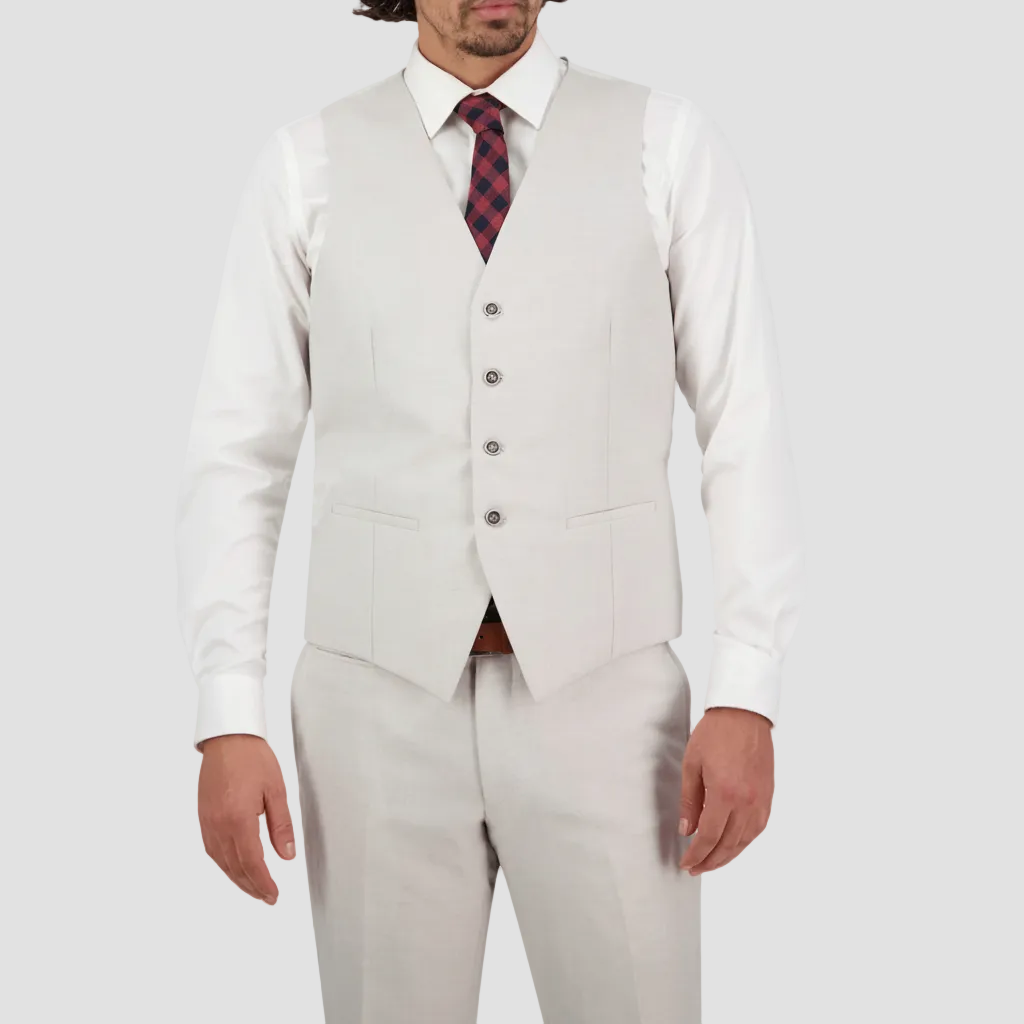 A man wearing a salt Savile Row tailored fit waistcoat with a four button front and satin back with an adjustable tab, paired with a white shirt and a tie.