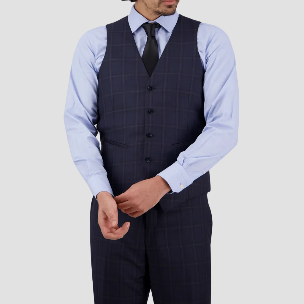 A man wearing a tailored fit midnight blue checkered vest with a four-button front and satin back, paired with a blue shirt and dark trousers.