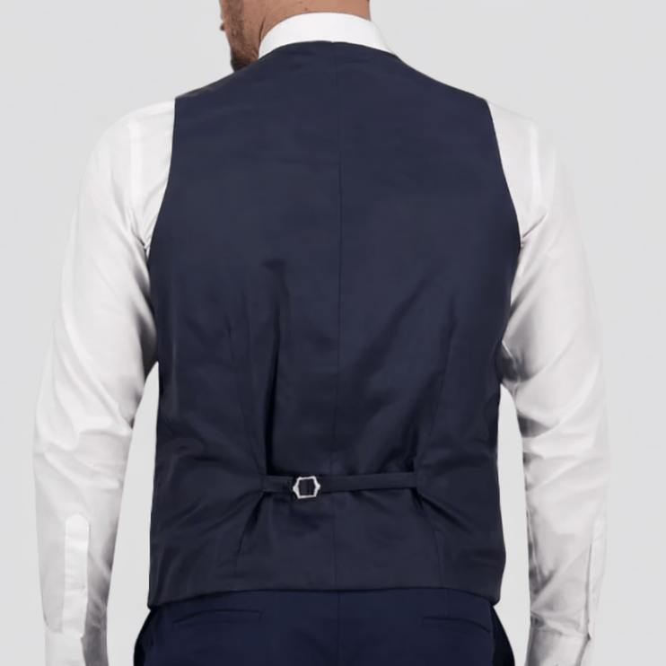 The Navy Saul Survivor Vest—tailored fit, four‑button front, and satin back.
