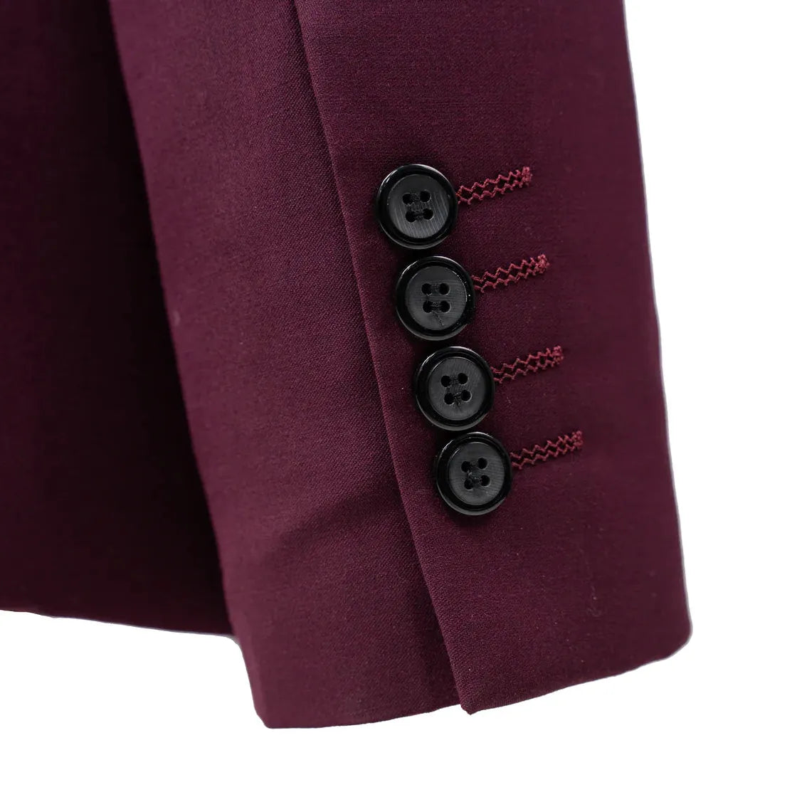 Close-up of a tailored jacket sleeve in deep burgundy, showing four black buttons with decorative red stitching and a clean white background.