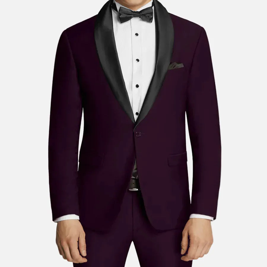 Man wearing a purple tuxedo with black lapels on a plain background