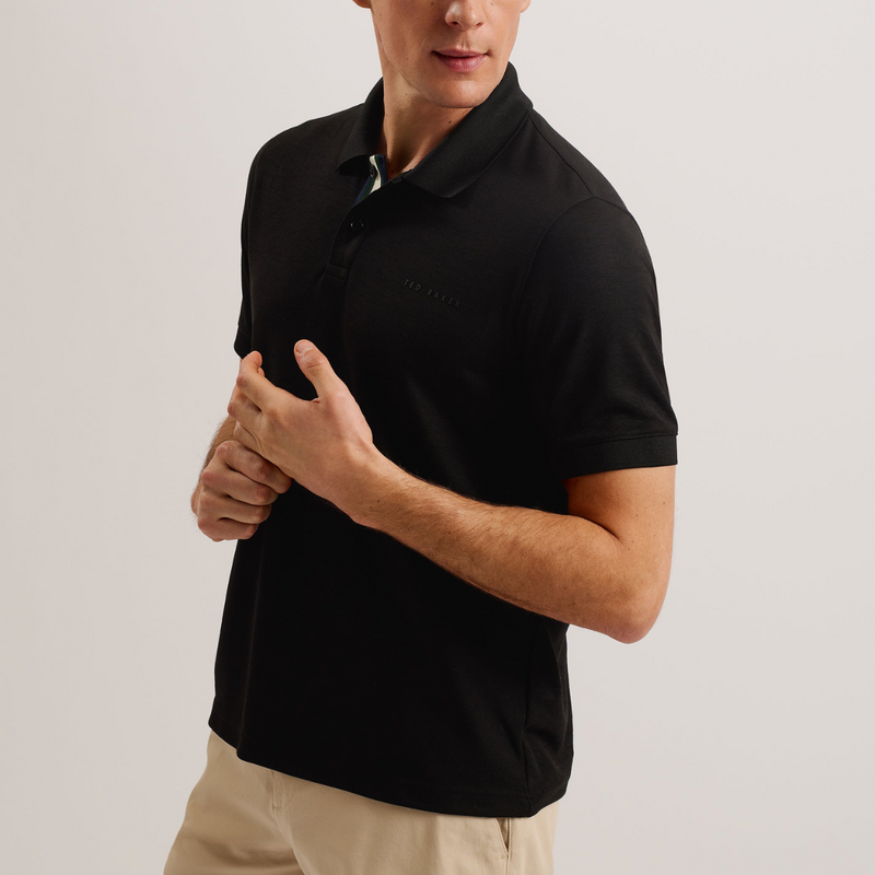 The Slim Fit Karty Mens Knit Polo in Black paired with cargo pants.