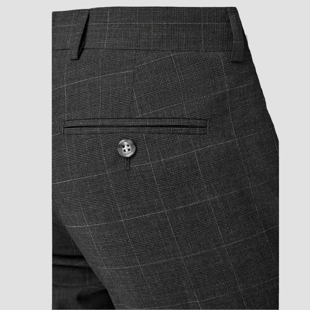 Gray checkered suit pants with a button on a light gray background