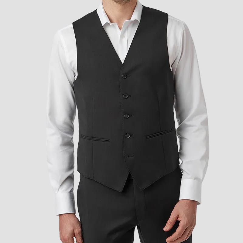 Man wearing a black vest over a white shirt on a white background