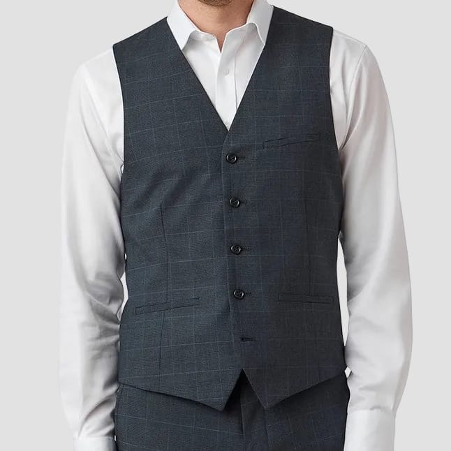 Man wearing a gray checkered vest over a white shirt on a white background