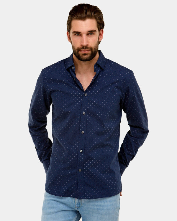 a man wears the brooksfield slim fit navy dotted dress shirt