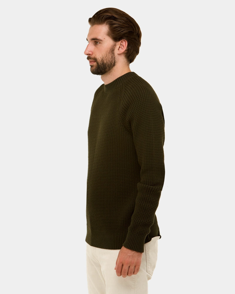 a side view of the mens slim fir knitted sweater in khaki green