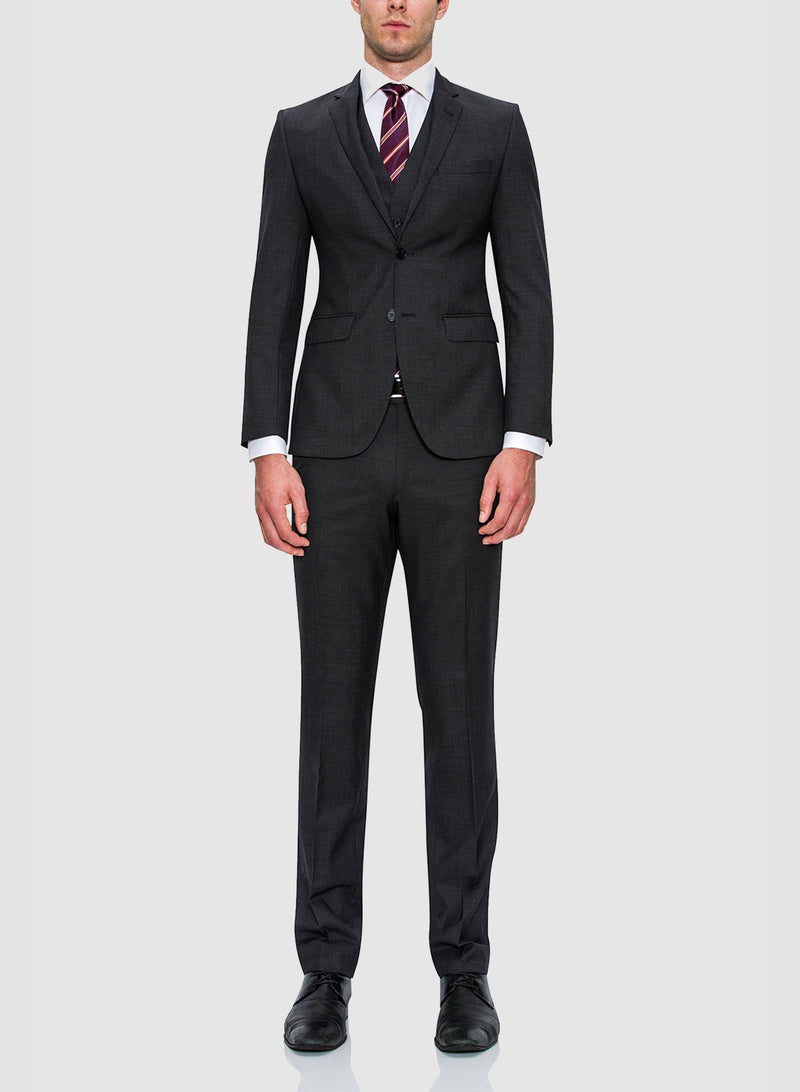 A full view of a model wearing the Cambridge classic fit range suit in charcoal pure wool F2800