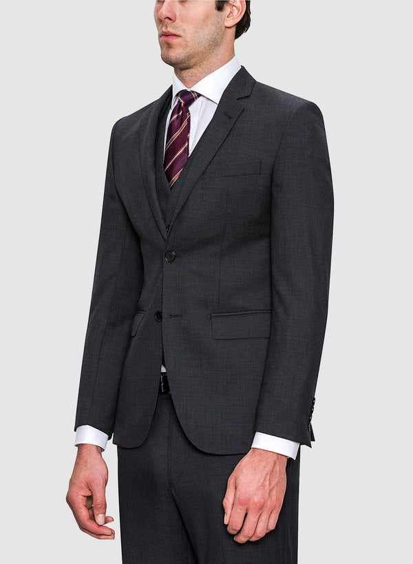 A side view of a model wearing the Cambridge classic fit range suit jacket in charcoal pure wool F2800