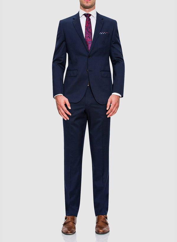 A full length image of a model wearing a Cambridge classic fit range suit in dark blue navy pure wool F2800