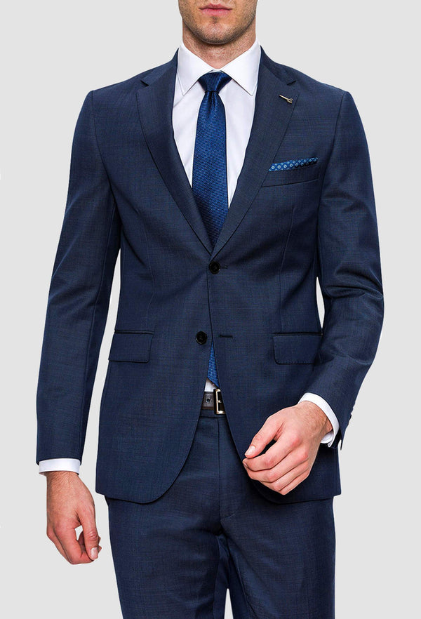 a man wears the joe black mission suit in a textured navy wool 