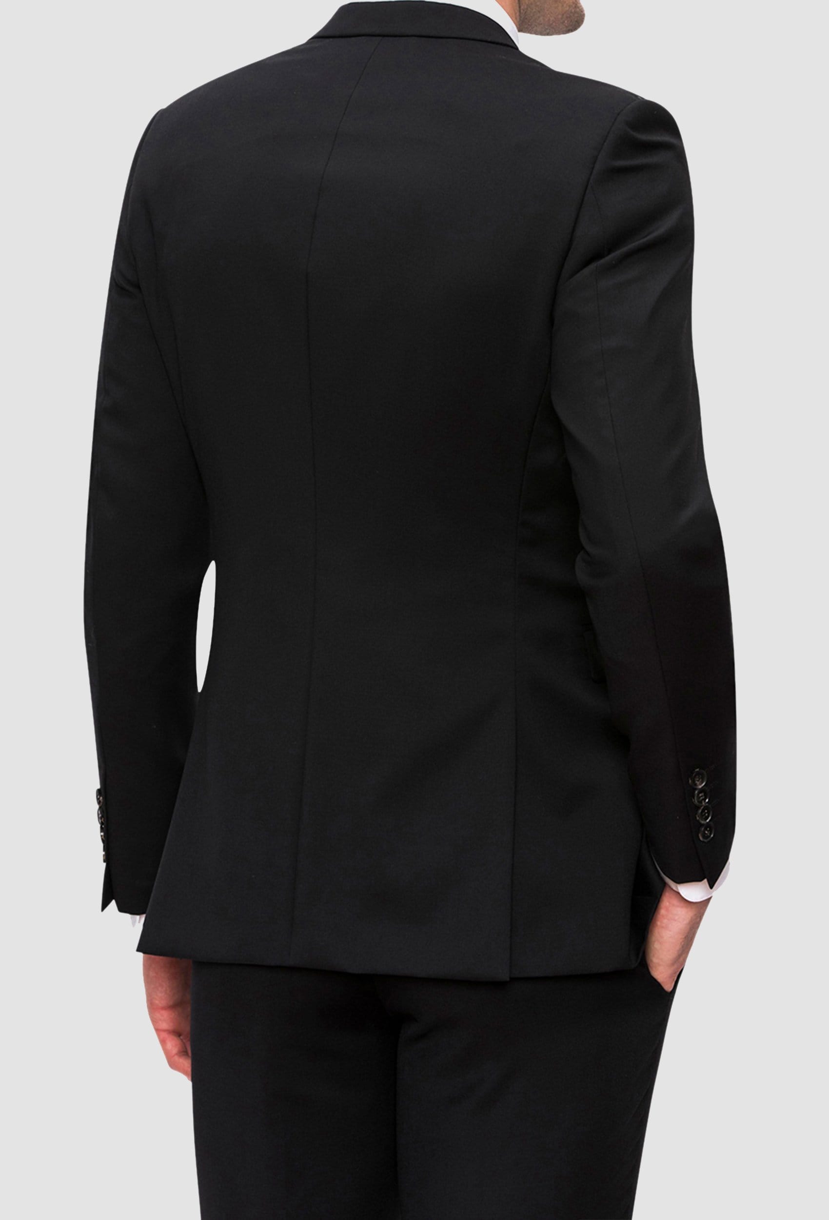 a reverse view of the Joe black anchor suit jacket in black pure wool styled with the razor trouser and a white shirt FJV032