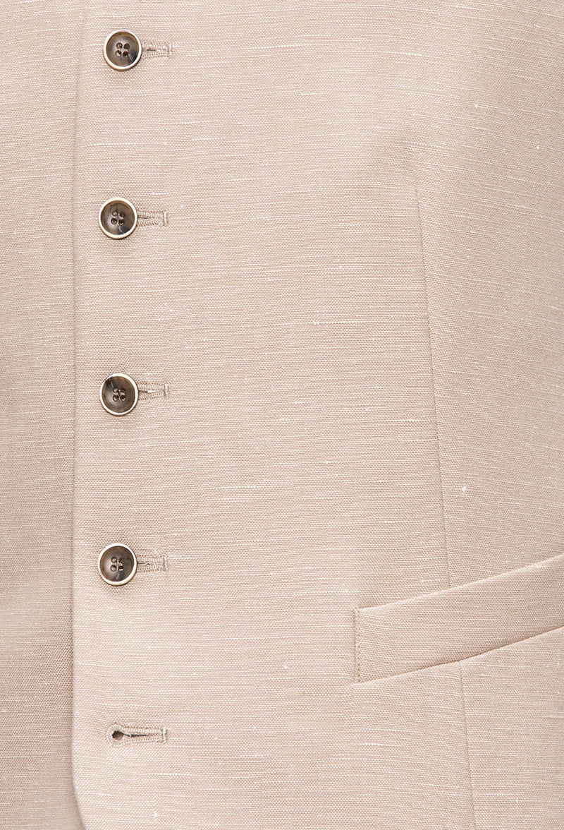 a close up view of the five button detail and angled welt pockets on the Joe Black slim fit mail vest in sand linen blend