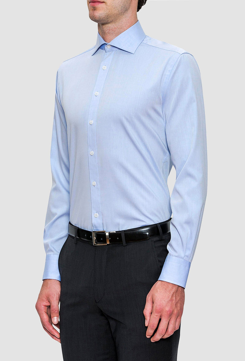 A side on view of a model wearing the Joe Black slim fit pioneer shirt in sky blue cotton FCE256