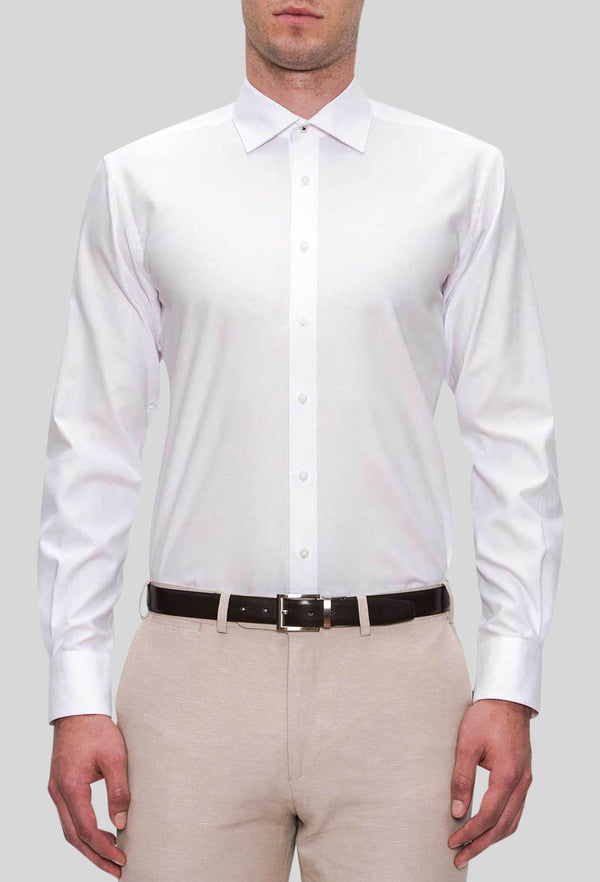 A front on view of the Joe Black slim fit pioneer shirt in white pure cotton FJD044 styled with a beige trouser