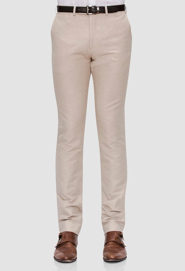 a front view of the Joe Black slim fit tourist sports trouser in sand styled with a black belt and white shirt
