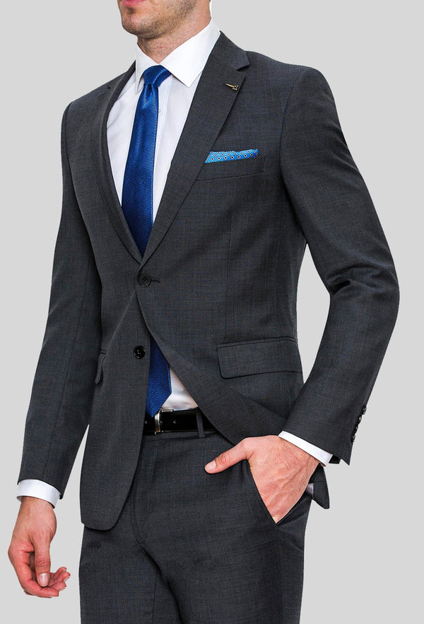 a side on view of a model wearing the Joe Black slim fit sergeant suit in charcoal pure wool FJD899