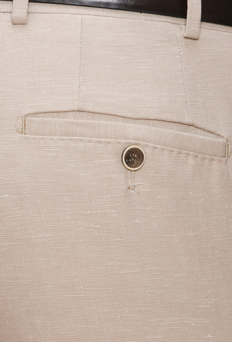 A close up view of the welt hip pockets with button closure on the Joe Black slim fit tourist sports trouser in sand linen blend