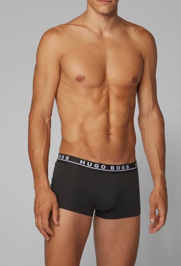 a model faces the front and wears the hugo boss three pack trunk in black stretch cotton 50325403