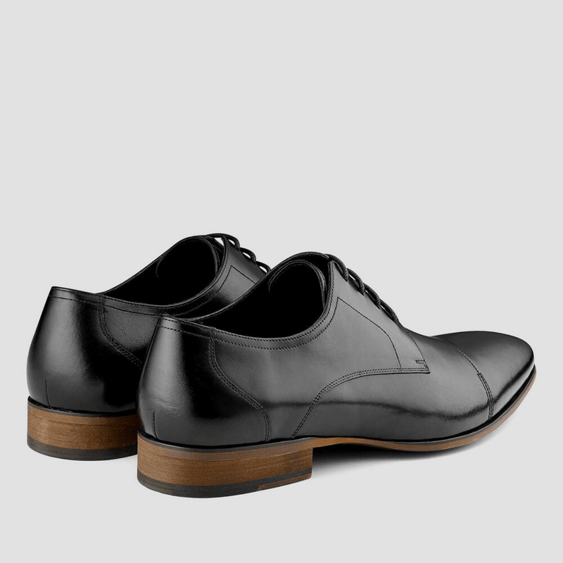 A classic round toe black leather shoe for men with a contrast rubber soul
