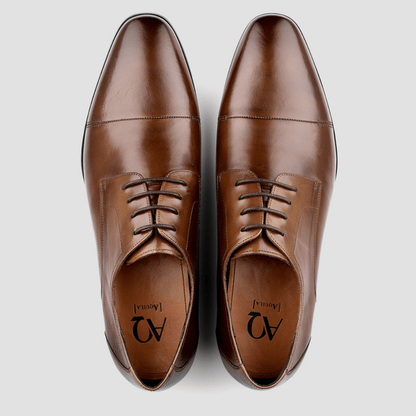 a mens tan leather shoe with brown laces and a slim design