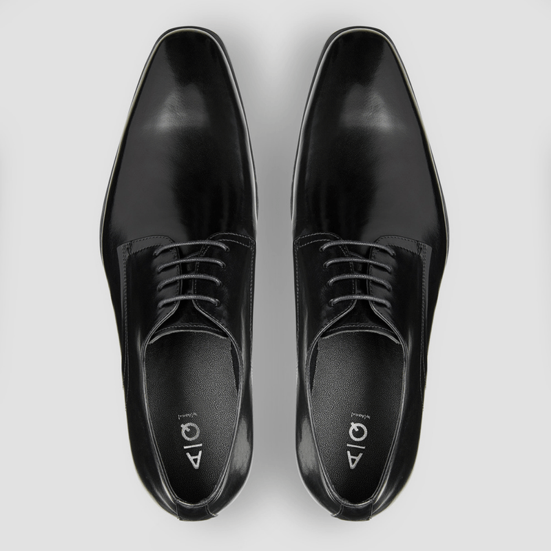 a pair of mens black leather dress shoes in a modern shape with black leather laces
