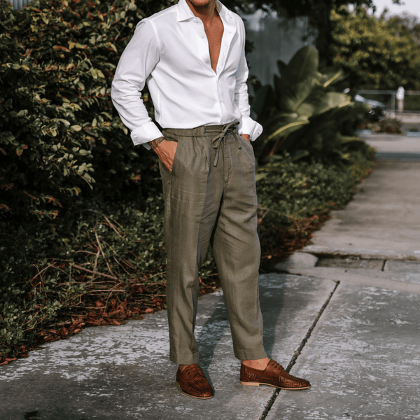 a man wears linen pants and shirt with the aquila rowan mens casual shoe in tan