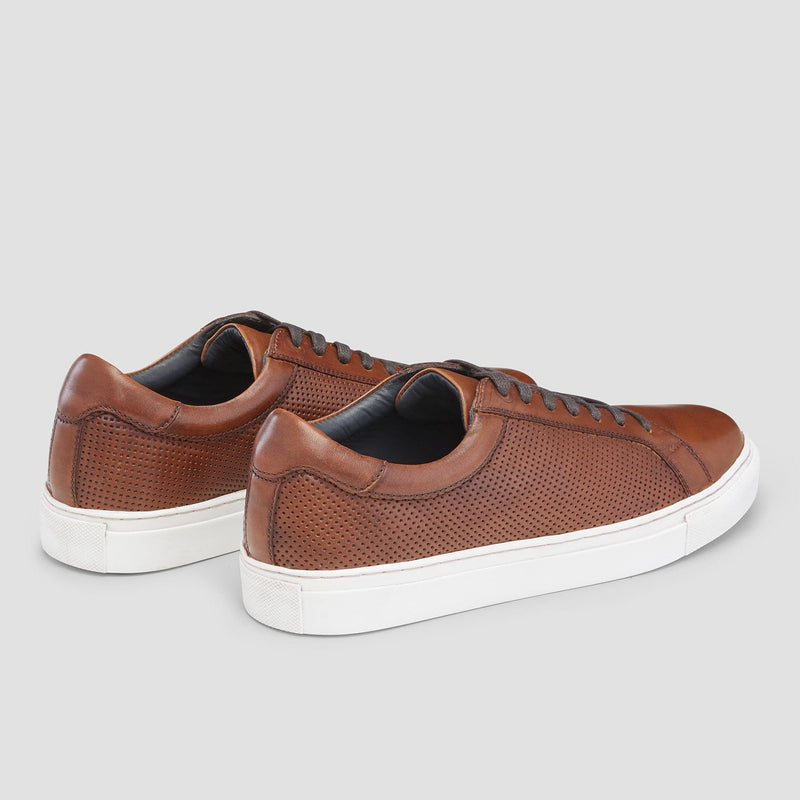 the perforated tan leather on the side of the mens aquila smith sneaker