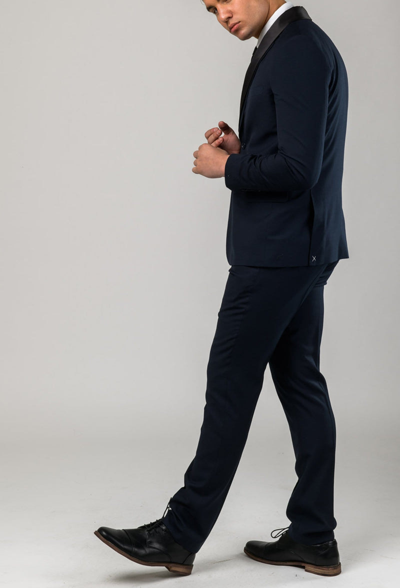 A side view of a model wearing the Aston slim fit laneport trouser in navy A049301T