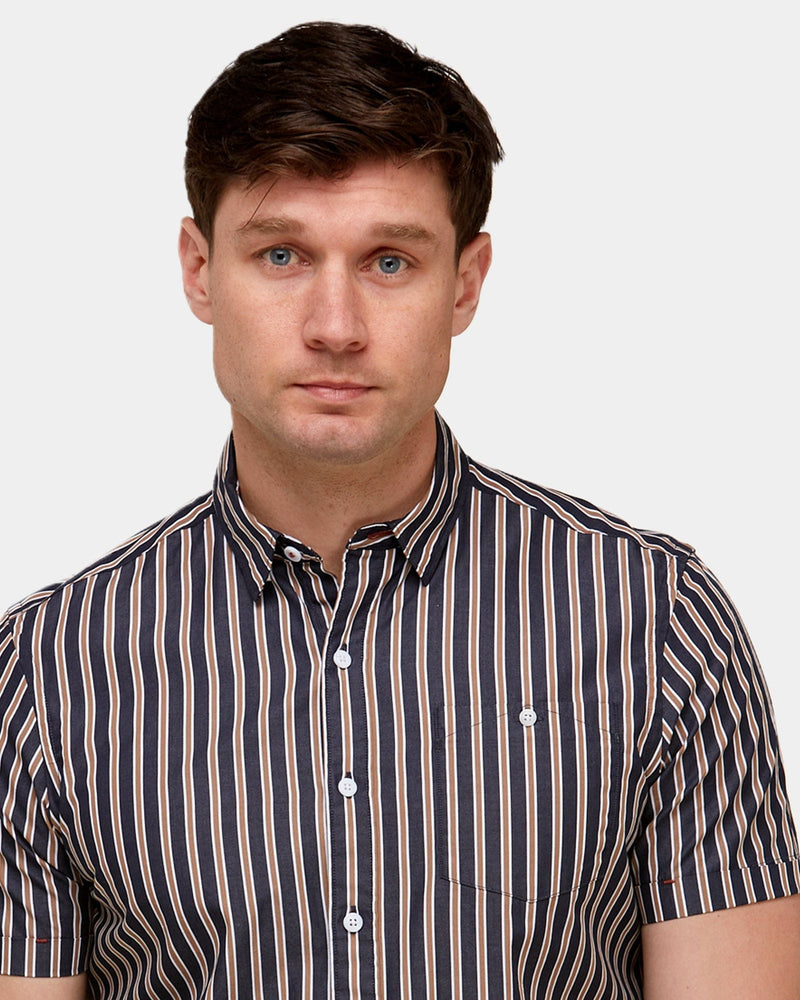 a black shirt with beige and white stripe designs with white buttons and a fixed collar