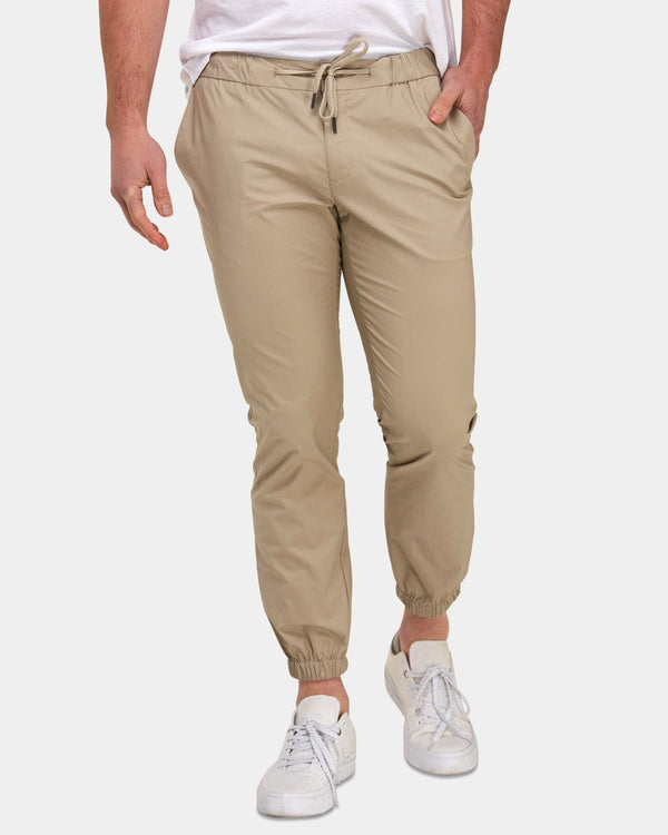 mens beige chino jogger with a white t-shirt and white sneakers