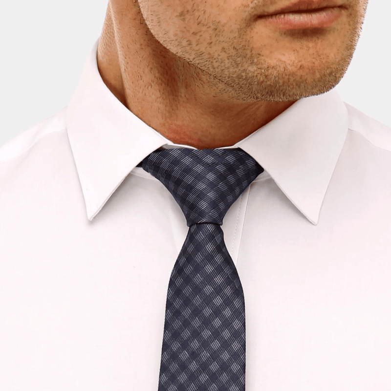 close up of the pointed collar on the brooksfield mens white shirt with a blue checked tie