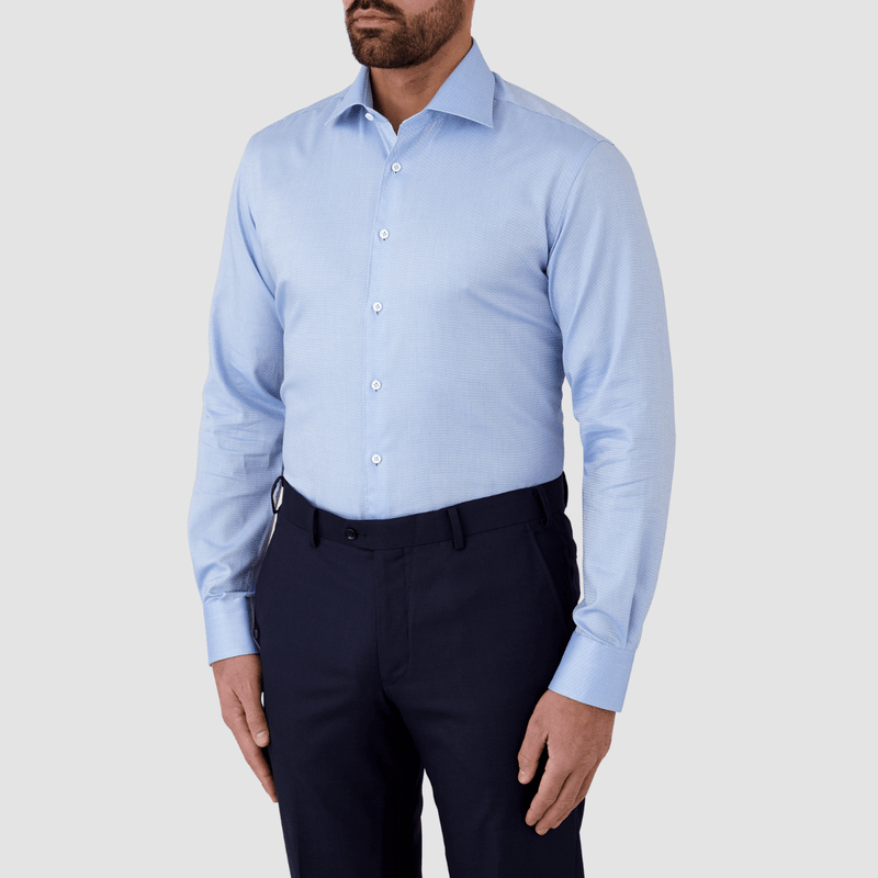 side view of the blue classic fit shirt worn with navy suit trousers