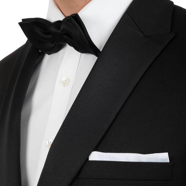 a black tuxedo with a satin peak lapel and black bow tie