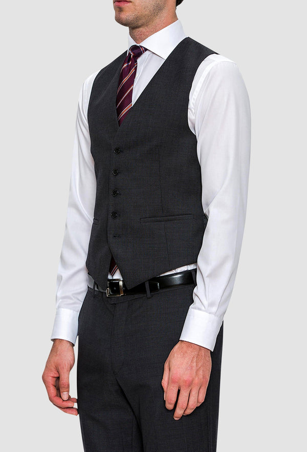 A model wears the Cambridge classic fit beaumont vest in charcoal pure wool F2800 styled with a white shirt