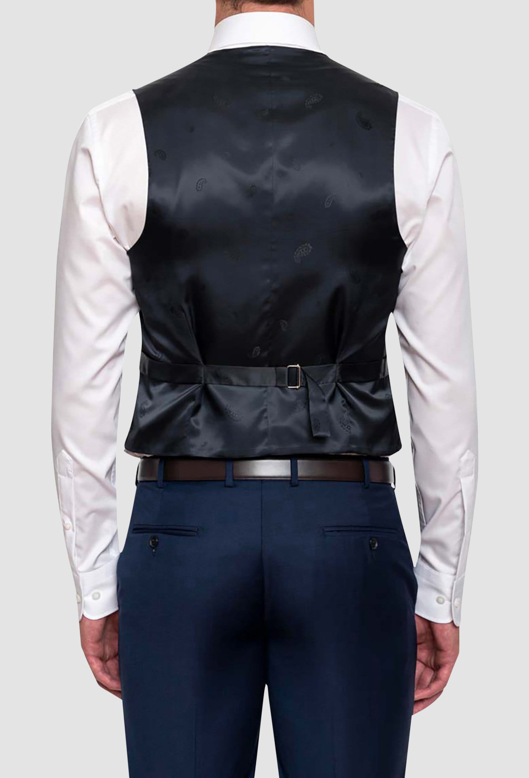 A back view of a model wearing the Cambridge classic fit beaumont vest in dark blue navy pure wool F2800, in particular you can see the detail of the tab adjuster at the back
