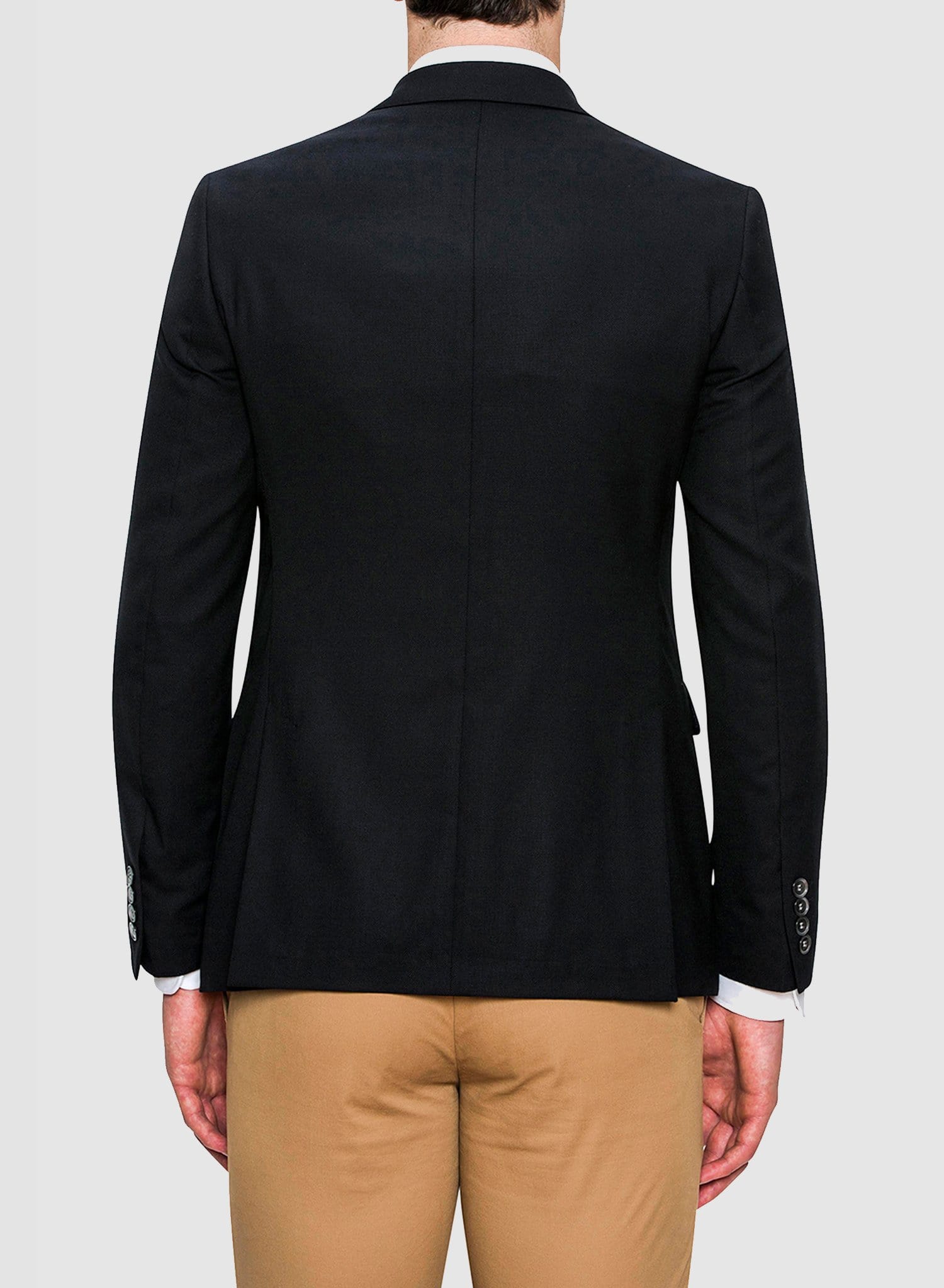 a back picture of a model wearing the cambridge classic fit unit sports jacket in navy with a white shirt and beige chino FCD012 the ultimate travel jacket
