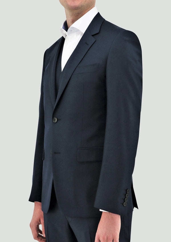 a front view of the daniel hechter slim fit ryan mens suit vest in deep blue merino wool STDH106-14 layered under the shape mens suit jacket in blue