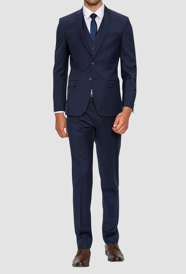 A front view of a model wearing the Gibson slim fit delirium mens suit in navy pure wool F3614 styled with a blue tie and white shirt