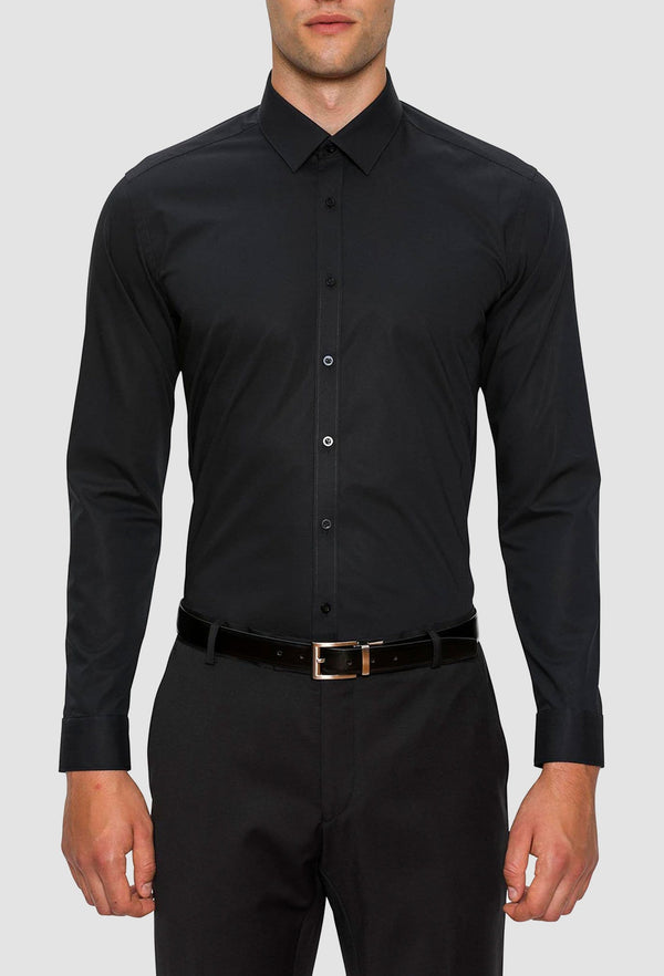 A model wears the Gibson slim fit fierce shirt in black FGC054 styled with a black belt and pant for an evening look