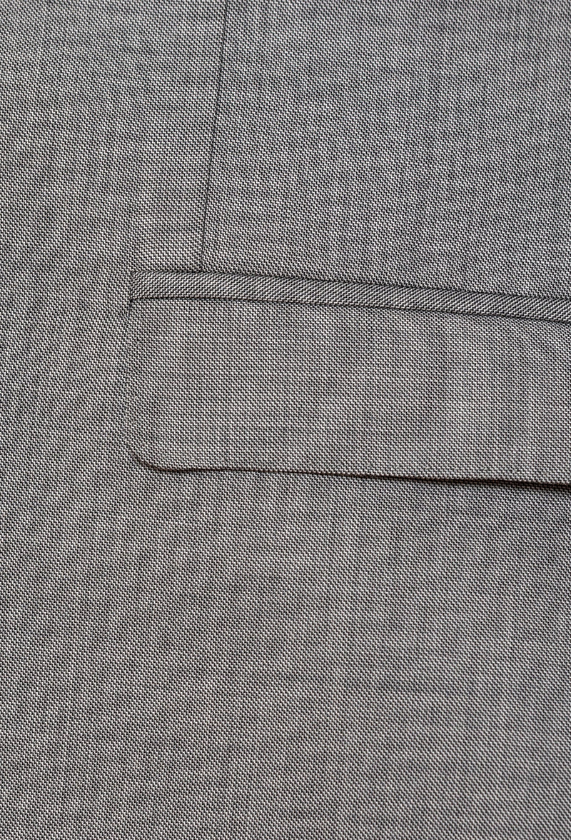 A close up view of the flat pocket detailing on the Gibson slim fit lithium suit jacket in grey pure wool FGE645