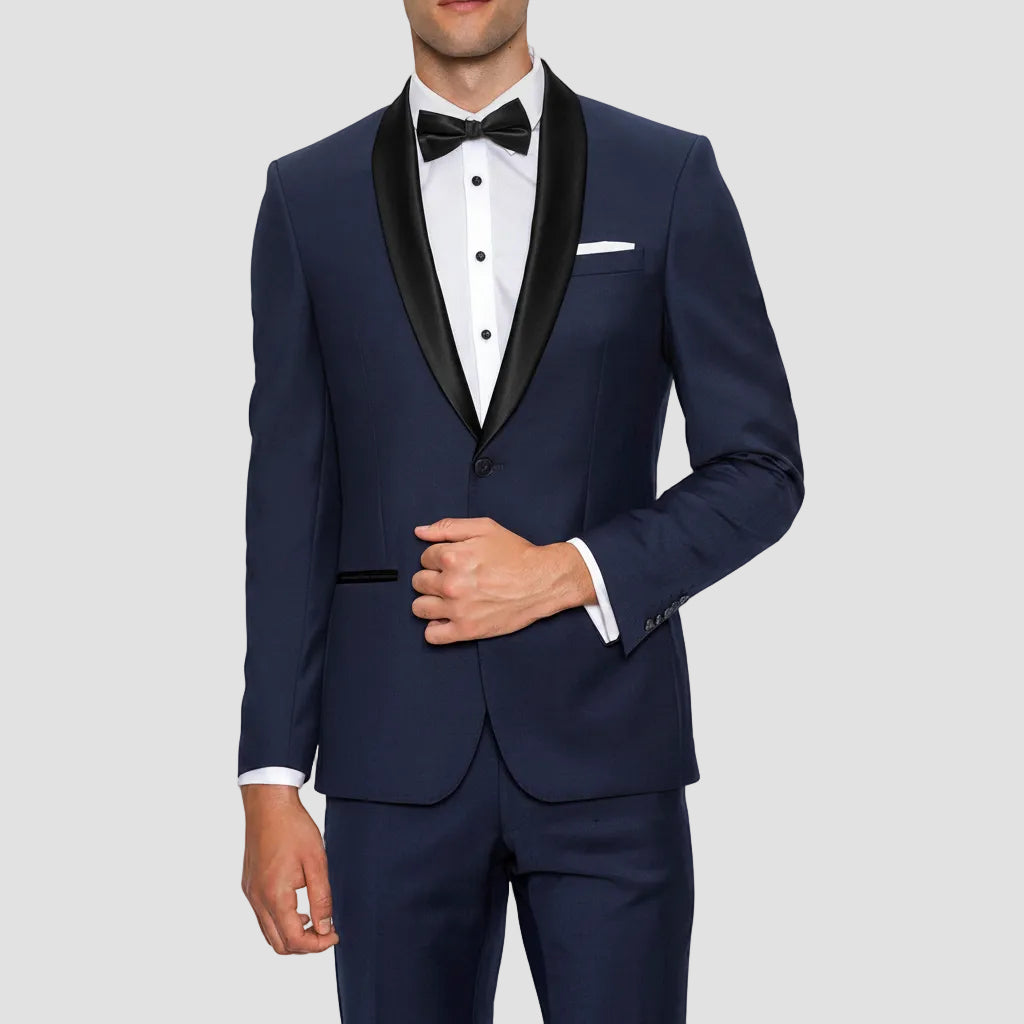 Gibson’s Spectre navy tuxedo blends a satin shawl lapel, jet pockets and 2‑button front with slim trousers.