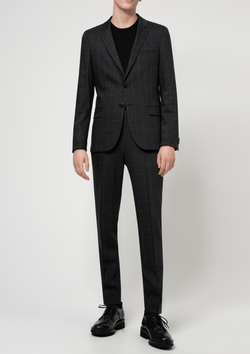 A model wears the Hugo menswear slim fit anfred 204 suit in charcoal